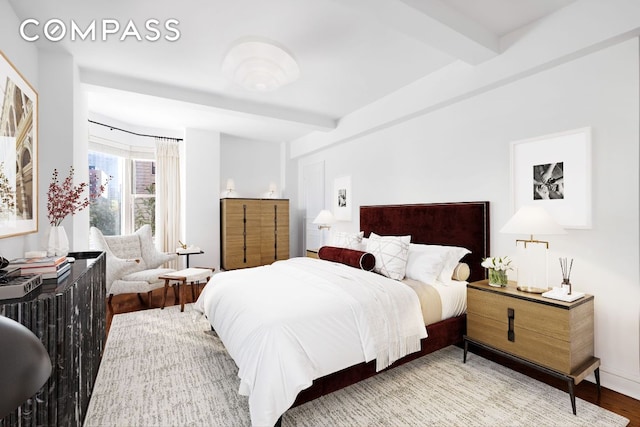 bedroom with beamed ceiling and hardwood / wood-style floors