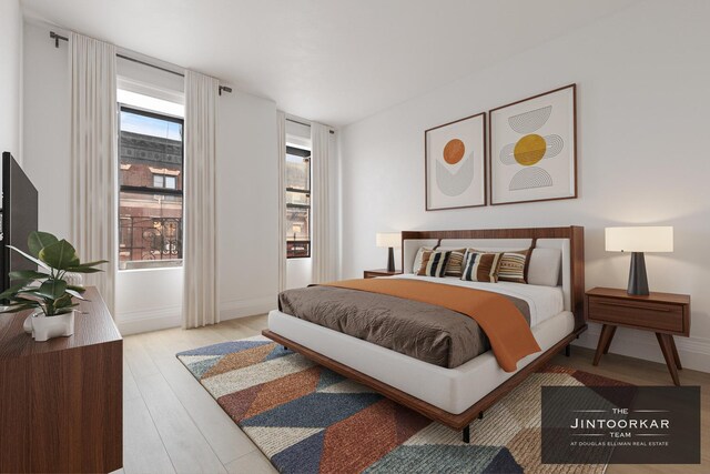 501 W 143rd St Unit 62, New York City, NY 10031 - bedroom with baseboards and light wood finished floors