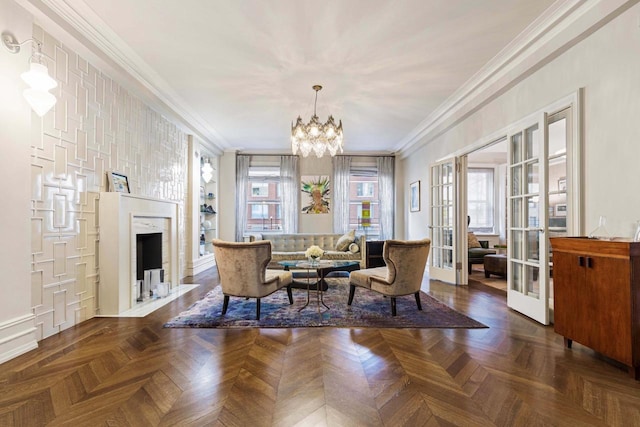 living area with a chandelier, ornamental molding, a high end fireplace, and french doors