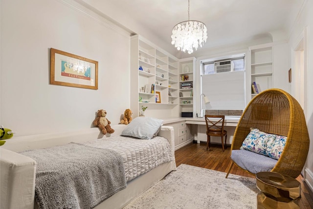 bedroom featuring dark wood-type flooring, a notable chandelier, and ornamental molding