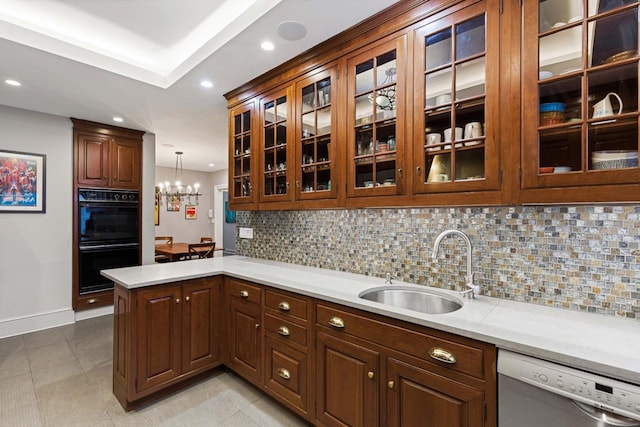 kitchen with dobule oven black, a sink, stainless steel dishwasher, a peninsula, and light countertops