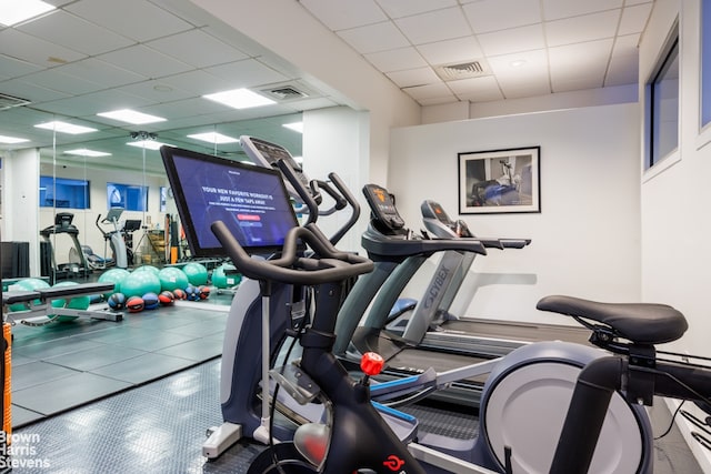 workout area with a paneled ceiling