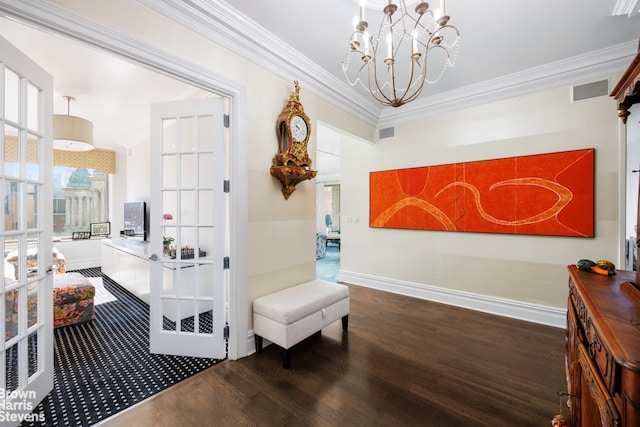 interior space featuring ornamental molding, an inviting chandelier, dark hardwood / wood-style flooring, and french doors