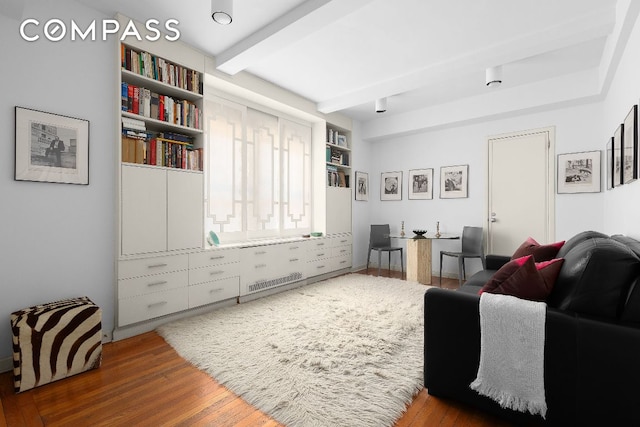 living room featuring dark hardwood / wood-style flooring and beamed ceiling