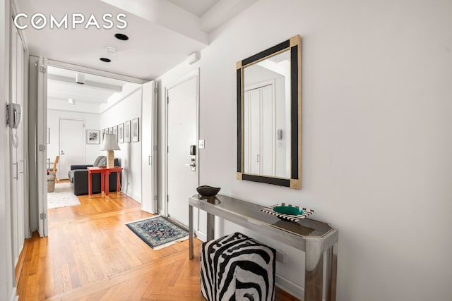 entryway featuring beamed ceiling and parquet floors