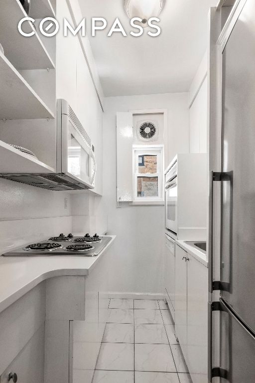 kitchen with white cabinetry and stainless steel appliances