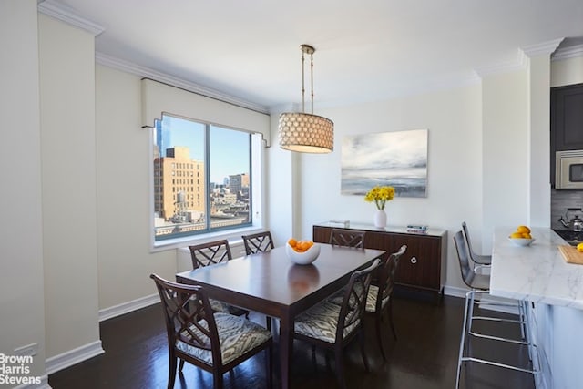 dining room with ornamental molding and dark wood-type flooring