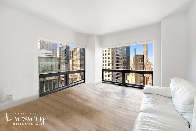 interior space featuring a view of city and wood finished floors