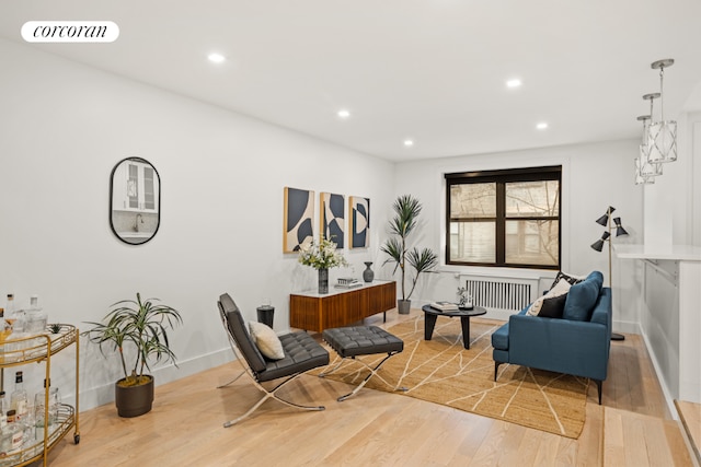 sitting room featuring hardwood / wood-style flooring and radiator heating unit