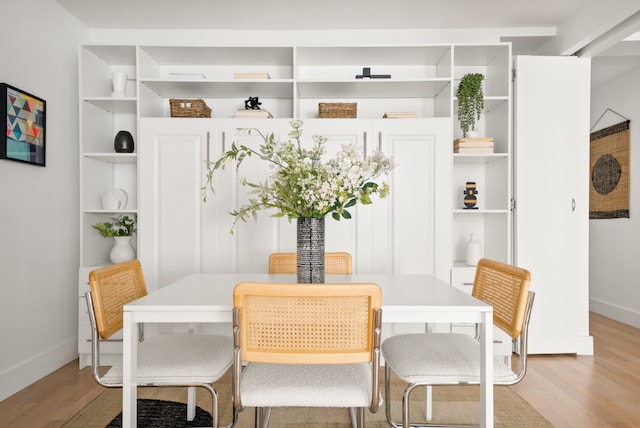 dining space with light hardwood / wood-style floors