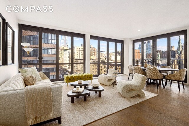 living room with hardwood / wood-style floors and expansive windows