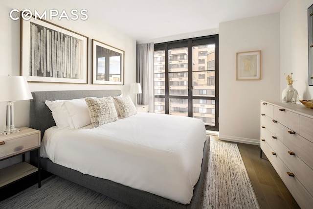 250 W 96th St Unit 9C, New York City, NY 10025 - bedroom with baseboards and dark wood finished floors
