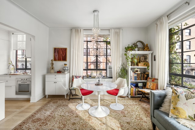 224 E 17th St Unit 2F, New York City, NY 10003 - dining room featuring light wood finished floors and a chandelier