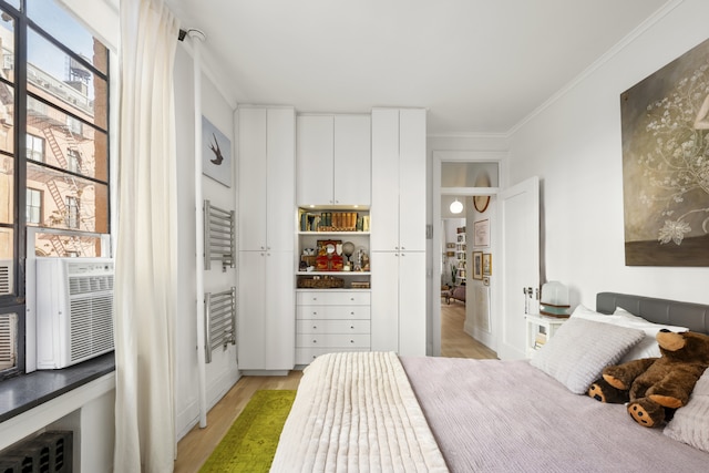 bedroom with light wood-type flooring and ornamental molding