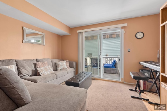 living area featuring a wealth of natural light, light carpet, and baseboards