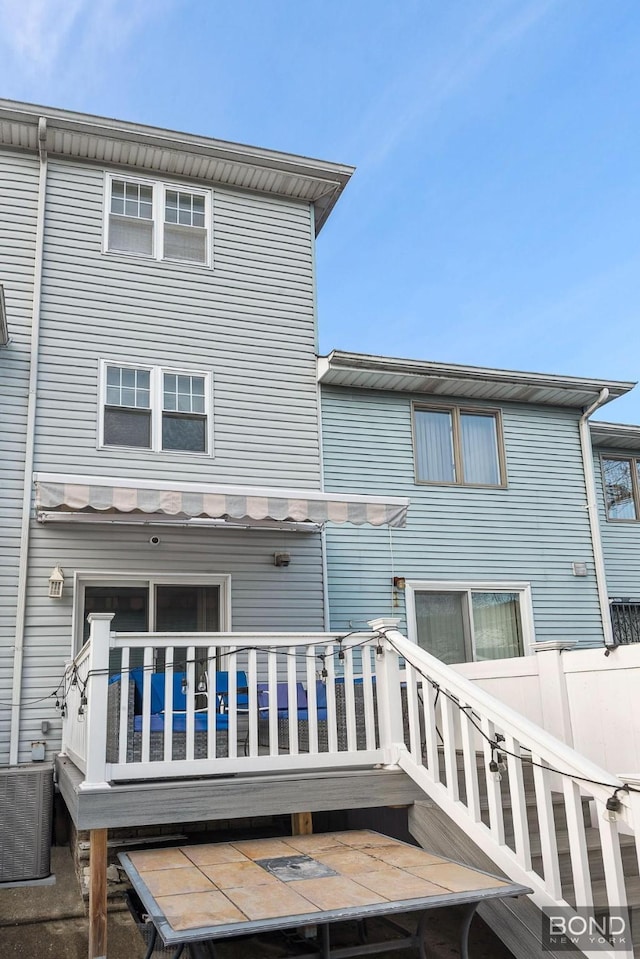 back of house featuring a wooden deck and central AC unit