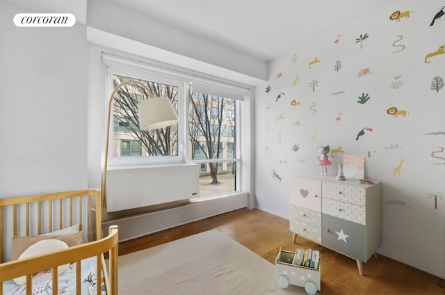 bedroom with hardwood / wood-style flooring