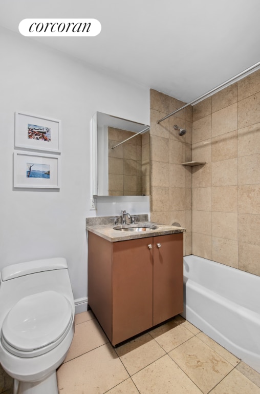 full bathroom featuring tile patterned flooring, vanity, tiled shower / bath, and toilet