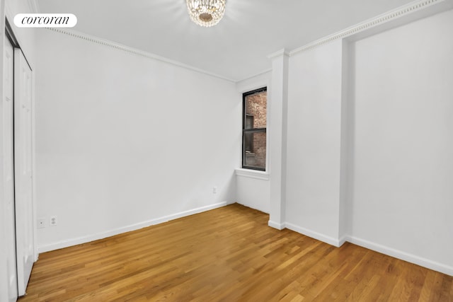 unfurnished bedroom with visible vents, baseboards, and wood finished floors