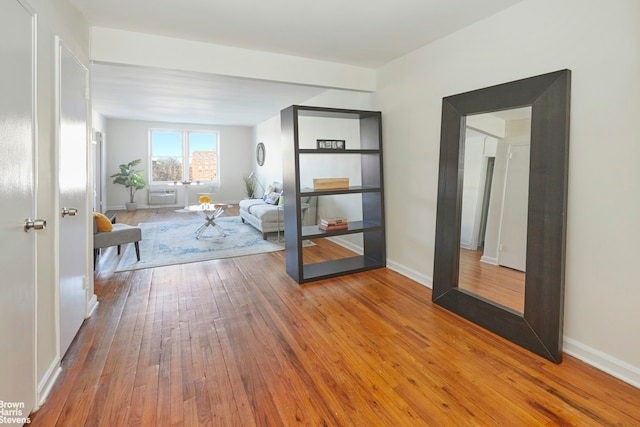 interior space featuring baseboards and hardwood / wood-style floors