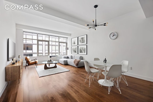 living room featuring a notable chandelier and wood-type flooring