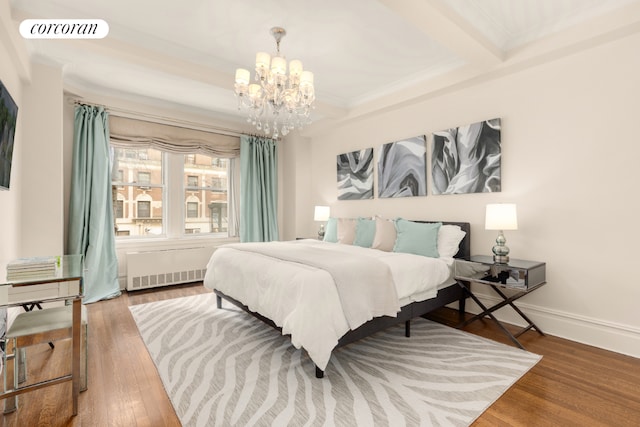 bedroom with baseboards, visible vents, radiator heating unit, ornamental molding, and wood finished floors