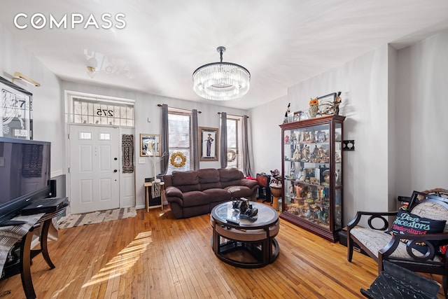 living area featuring an inviting chandelier and hardwood / wood-style floors