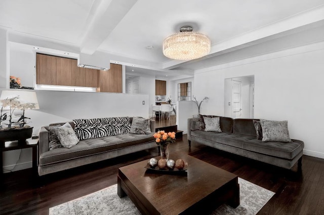 living room featuring a chandelier, beam ceiling, baseboards, and wood finished floors