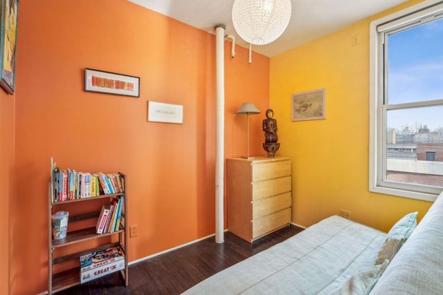 bedroom with dark wood-style floors and baseboards