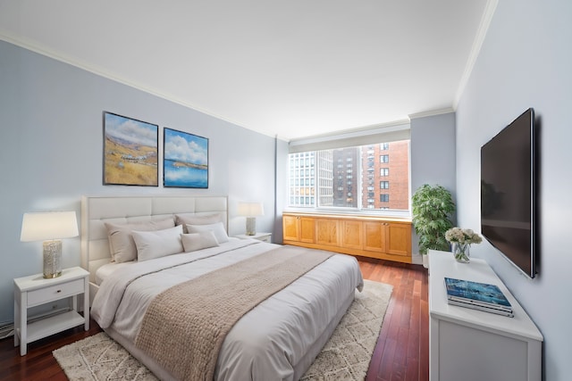 bedroom with dark wood-style flooring and crown molding