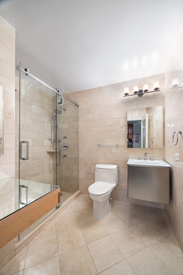 bathroom with vanity, a shower stall, toilet, and tile walls