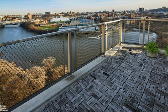 balcony with a view of city and a water view