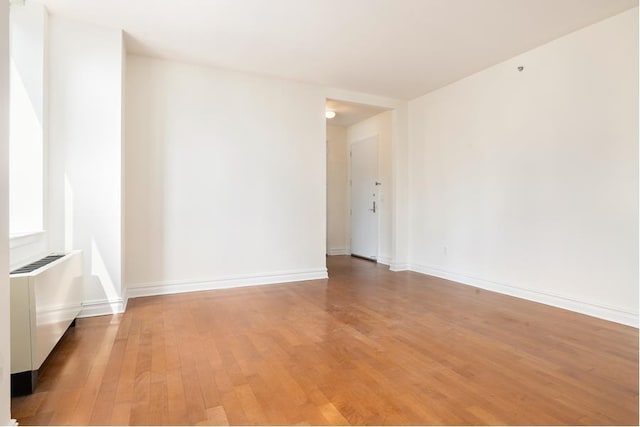 unfurnished room featuring light wood-style floors and baseboards