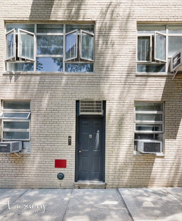 doorway to property featuring cooling unit