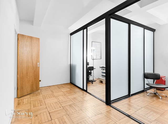 bedroom featuring light parquet floors and beam ceiling