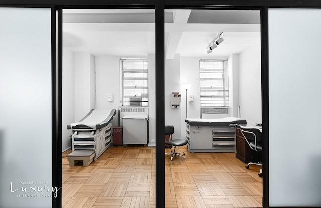 bathroom featuring parquet floors and track lighting