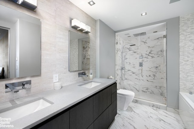 full bathroom with tile walls, vanity, independent shower and bath, and toilet