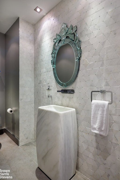 bathroom featuring tile patterned floors and tile walls