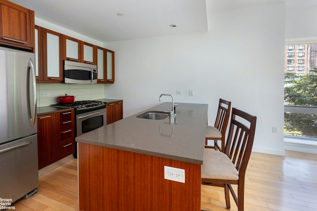 3585 Greystone Ave Unit 3De, New York City, NY 10463 - kitchen featuring stainless steel appliances, a sink, a kitchen bar, and plenty of natural light