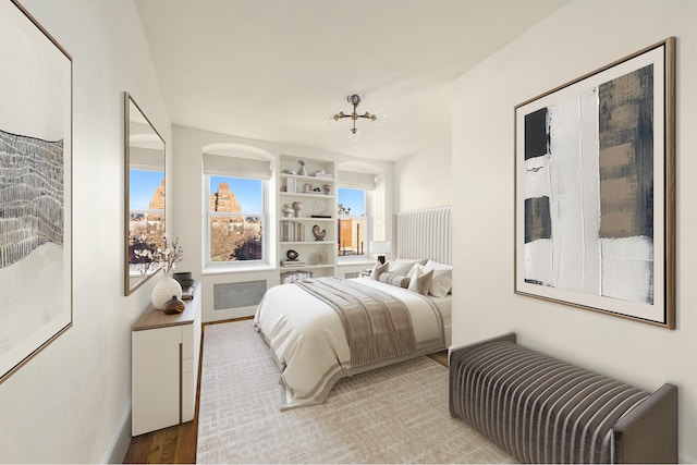 bedroom with baseboards and light wood finished floors