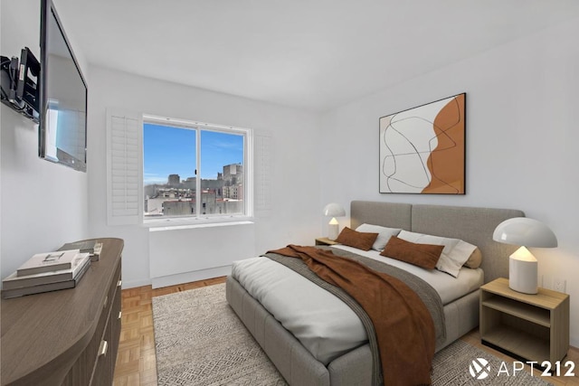 bedroom with light parquet flooring