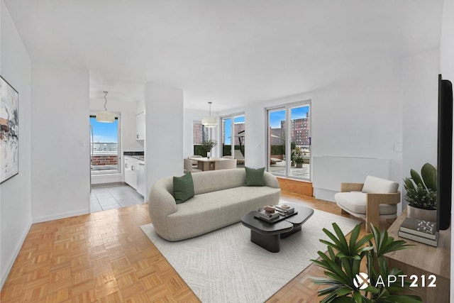 living room with plenty of natural light and light parquet floors