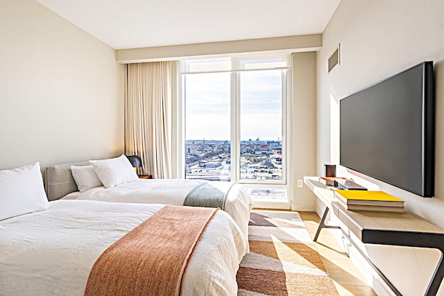 bedroom featuring light wood-style flooring and visible vents