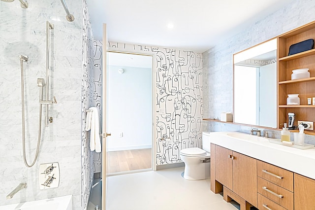 bathroom featuring tiled shower, vanity, and toilet