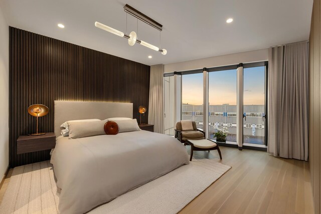 bedroom featuring access to outside, light wood-style flooring, and recessed lighting