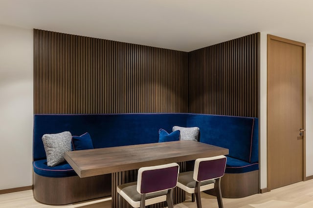 dining space featuring light wood-style flooring and baseboards