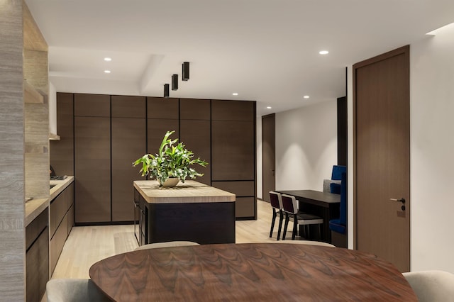 kitchen with a center island, light countertops, light wood finished floors, and modern cabinets