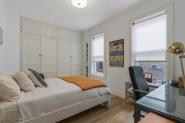 bedroom featuring light hardwood / wood-style floors and a closet