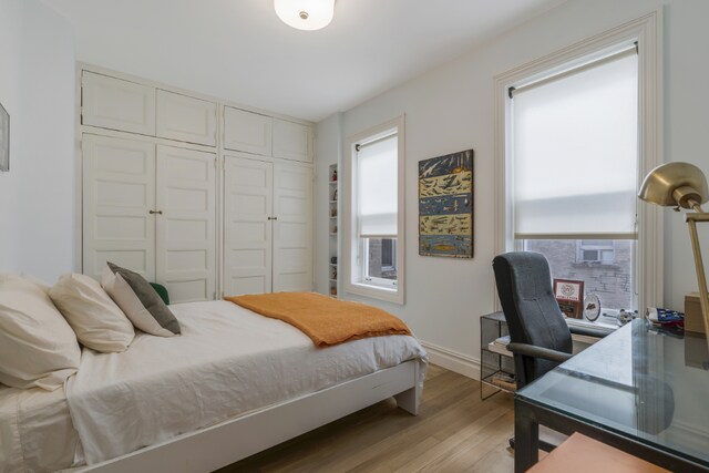 bedroom with a closet and light hardwood / wood-style flooring