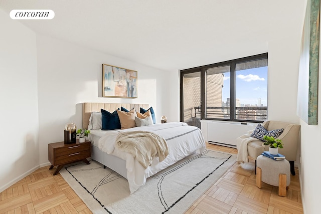 330 E 38th St Unit 27A, New York City, NY 10016 - bedroom featuring baseboards and a city view